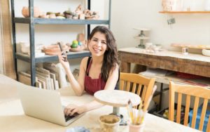 woman at table working on computer